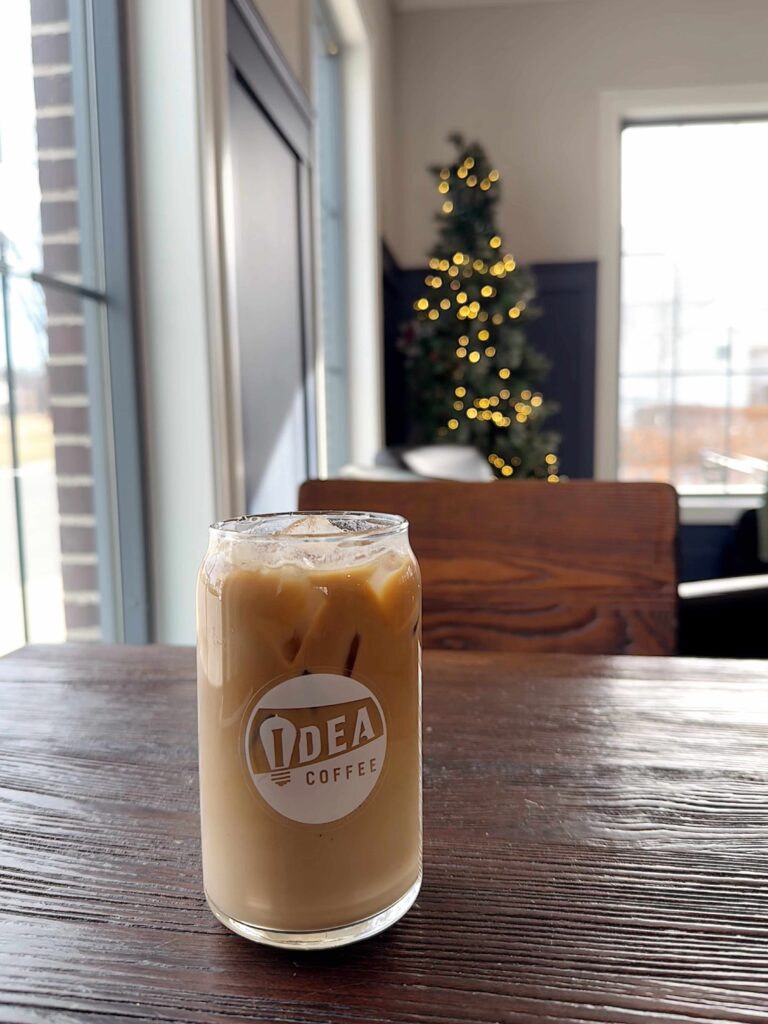 Glass coffee cup with Idea Coffee's logo