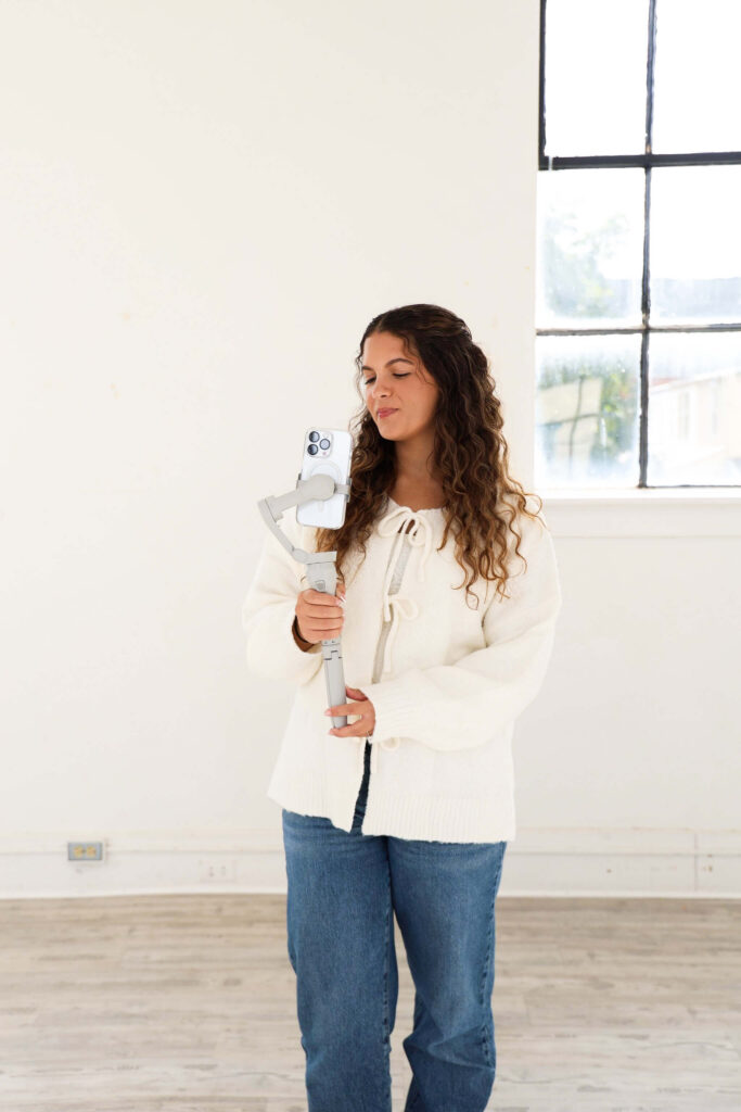 Inspired Social Studio owner using a gimbal to film content for social media