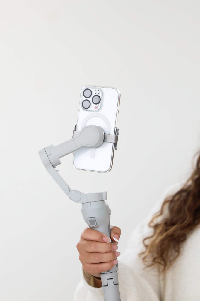 Content creator using a gimbal stabilizer to film content for social media