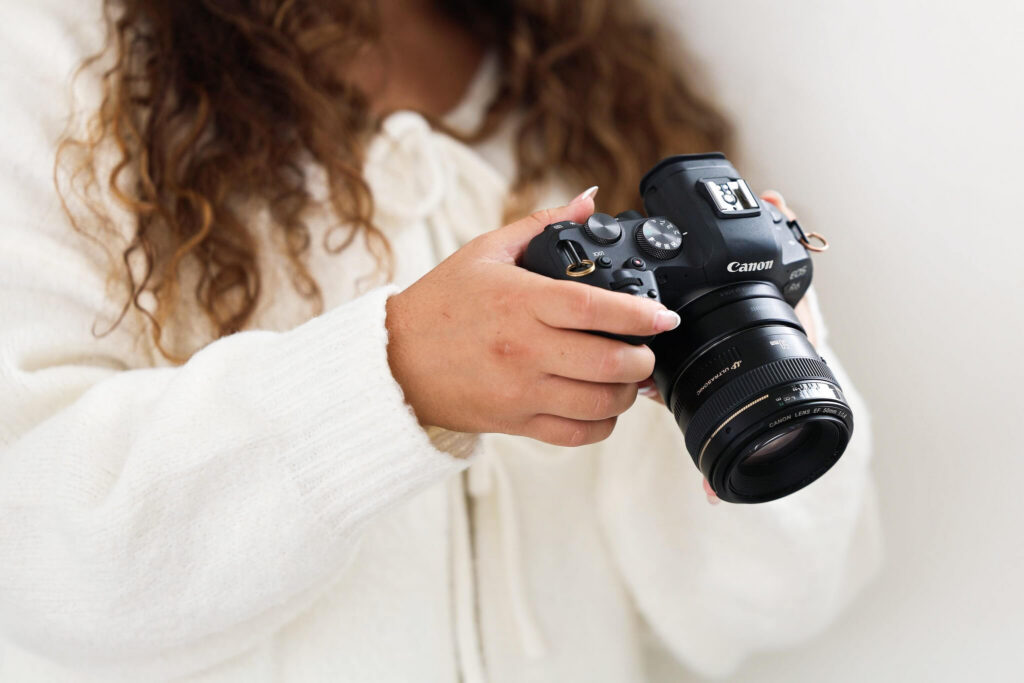 Female photographer looking at her camera