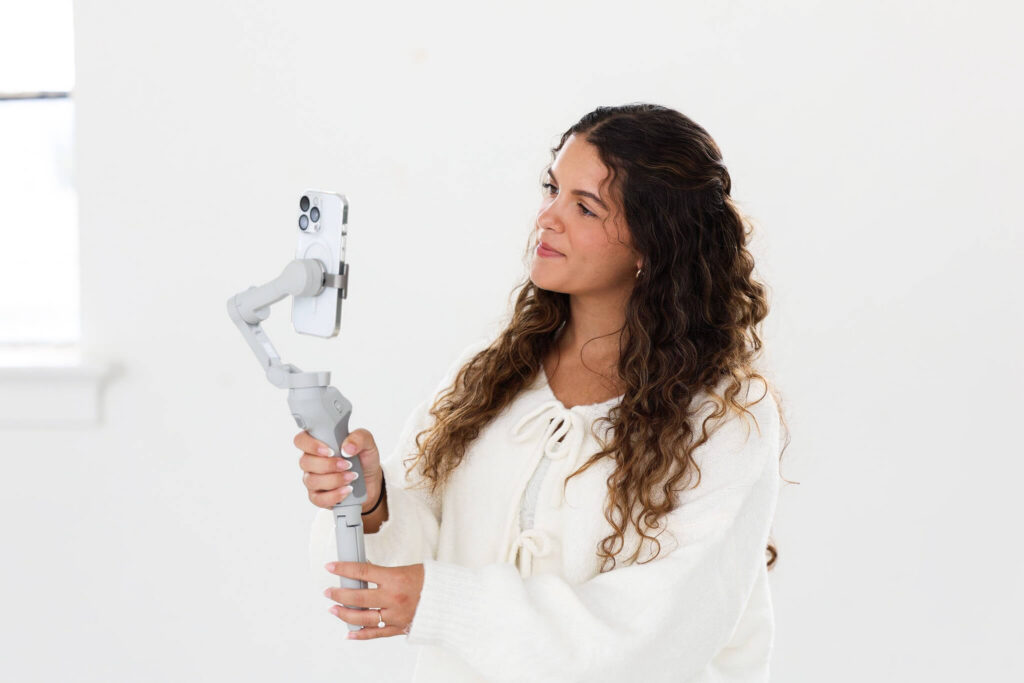 Social media manager filming short form video for a small business Instagram page